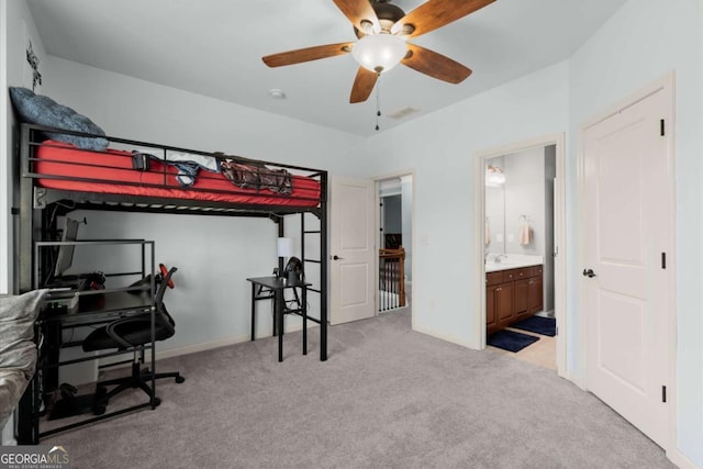 bedroom featuring baseboards, carpet, and ensuite bath