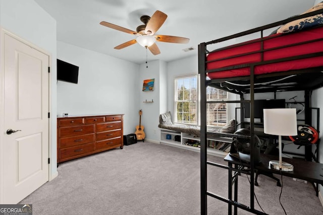 carpeted bedroom featuring visible vents, ceiling fan, and baseboards