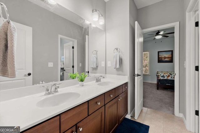 full bathroom featuring a sink, ensuite bath, tile patterned flooring, double vanity, and ceiling fan