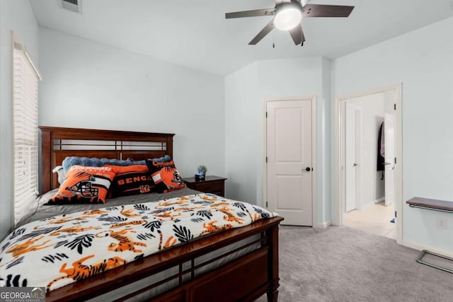 carpeted bedroom with visible vents, baseboards, and ceiling fan