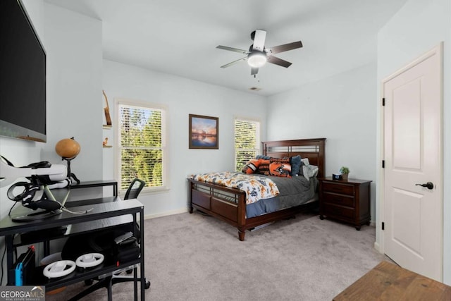 carpeted bedroom with baseboards and ceiling fan