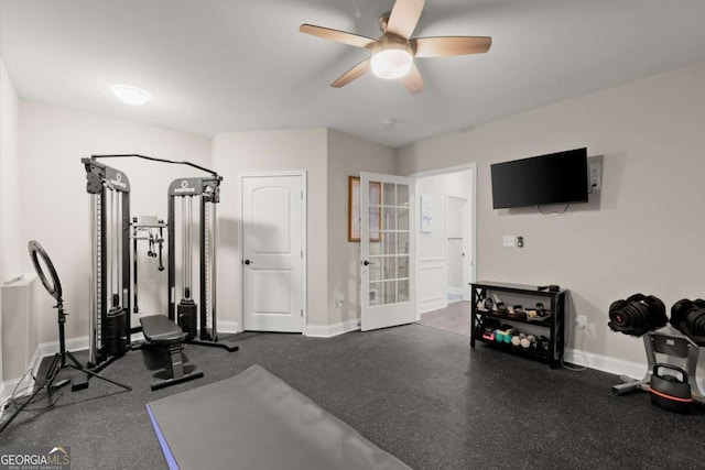 workout room featuring a ceiling fan and baseboards