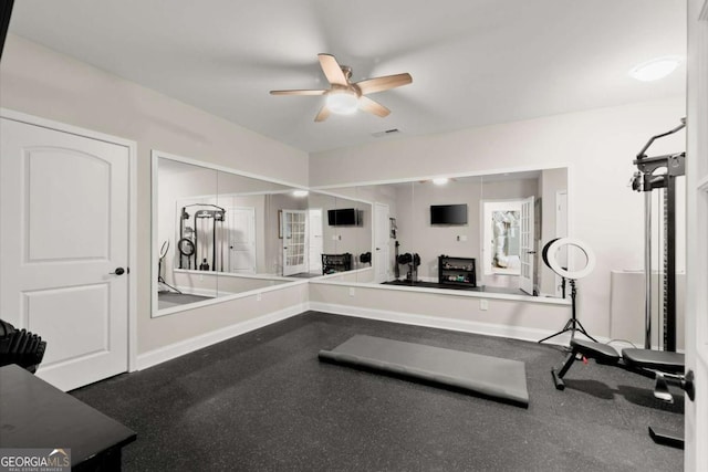 exercise area with visible vents, baseboards, and ceiling fan