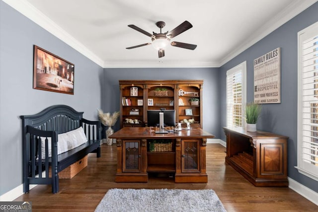 office space with ornamental molding, wood finished floors, baseboards, and ceiling fan