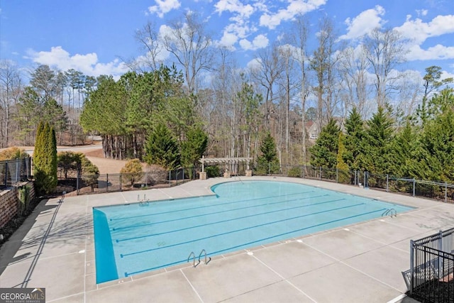 community pool featuring a patio area and fence