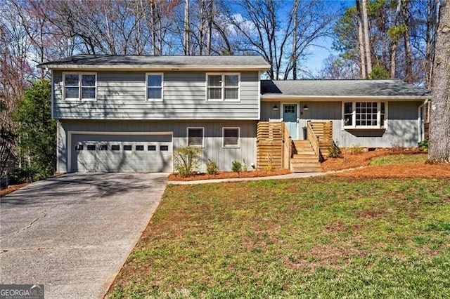 split level home featuring an attached garage, driveway, and a front lawn