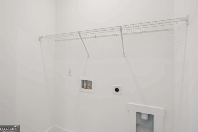 laundry area with laundry area, hookup for a washing machine, and hookup for an electric dryer