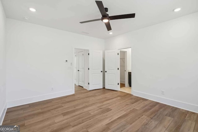 unfurnished bedroom featuring recessed lighting, light wood-style flooring, and baseboards