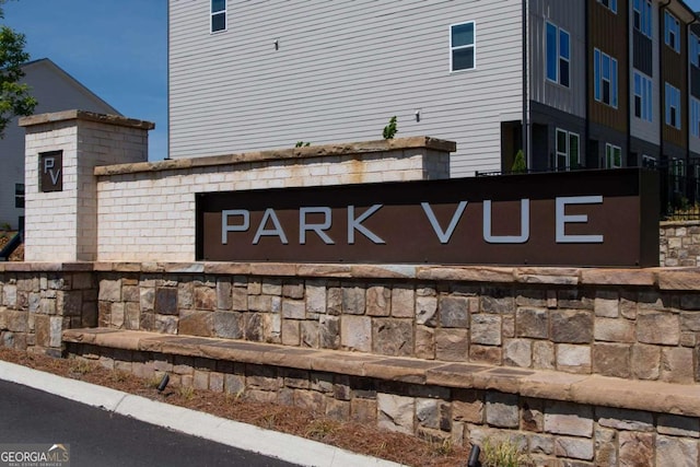 community / neighborhood sign featuring an attached garage