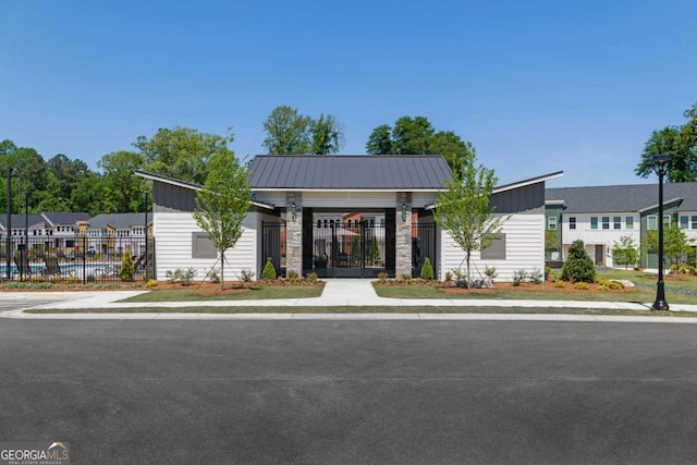 view of building exterior featuring a residential view and fence