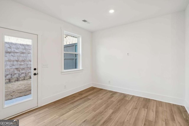 empty room featuring recessed lighting, visible vents, baseboards, and light wood-style floors