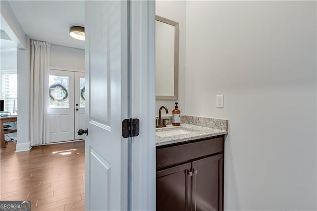 bathroom with vanity and wood finished floors