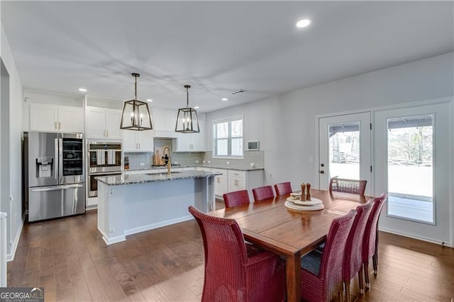 dining room featuring dark wood-type flooring and recessed lighting