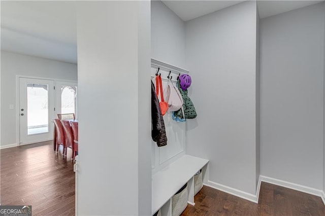 mudroom featuring dark wood-type flooring and baseboards