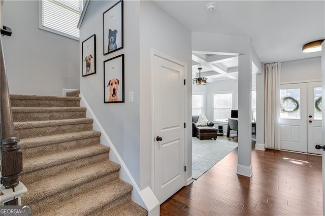 entryway featuring dark wood-style floors, baseboards, coffered ceiling, stairs, and beamed ceiling