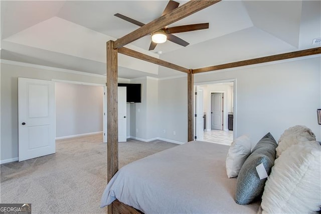 bedroom featuring baseboards, light carpet, a raised ceiling, and ornamental molding