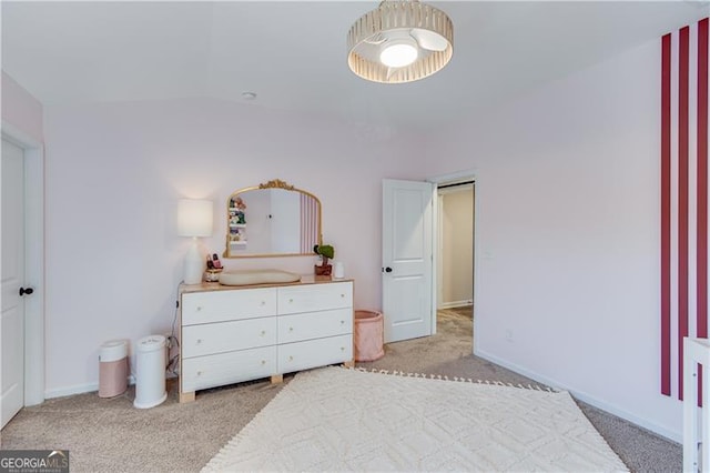 bedroom with light carpet and baseboards