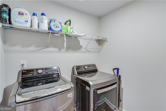 clothes washing area with independent washer and dryer and laundry area