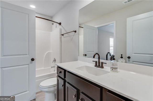 bathroom with visible vents, toilet, vanity, and shower / bathing tub combination