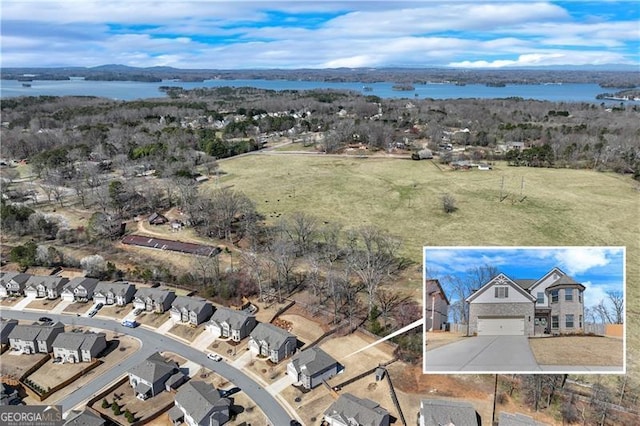 bird's eye view featuring a residential view and a water view