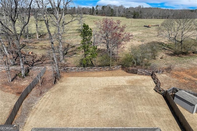 view of yard with a rural view and fence