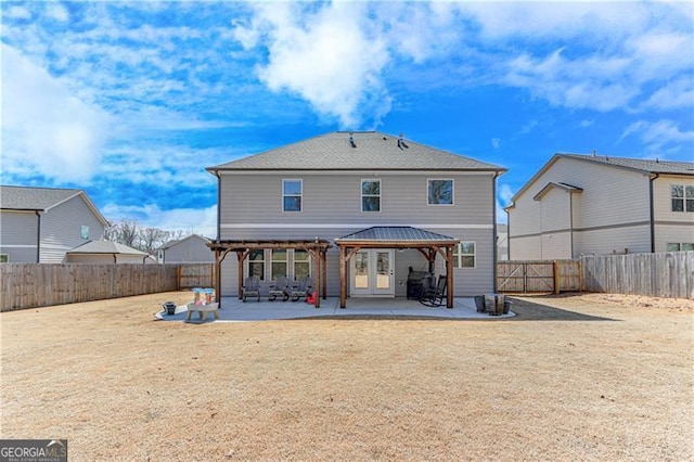 rear view of property with a gazebo, a patio area, and a fenced backyard