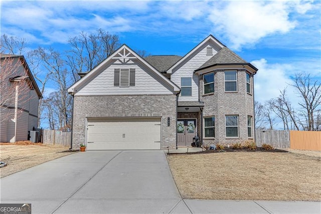 view of front facade featuring brick siding, concrete driveway, and fence