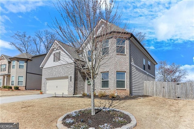 traditional home with brick siding, an attached garage, driveway, and fence