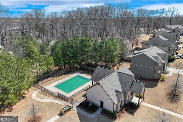 birds eye view of property with a forest view