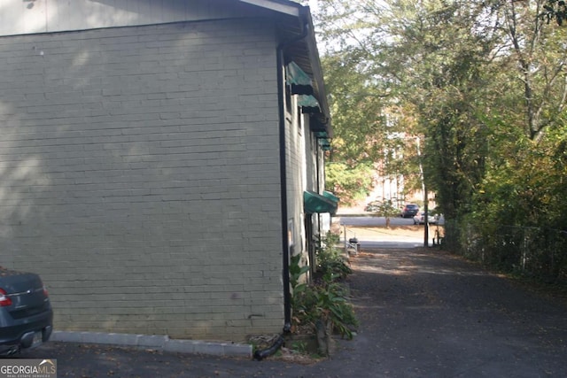 view of side of home featuring brick siding