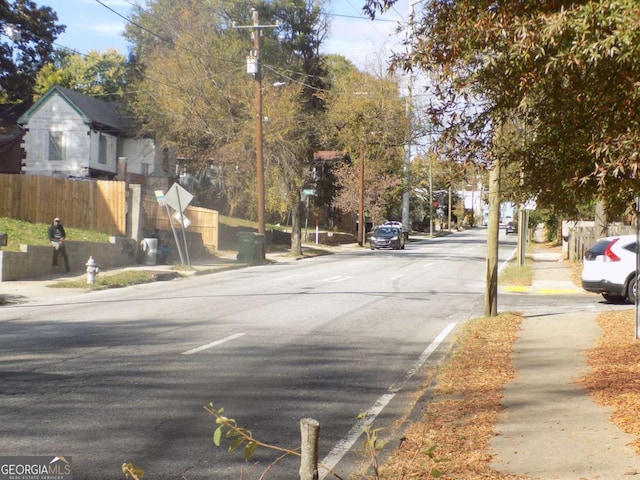 view of street with traffic signs, street lights, and sidewalks