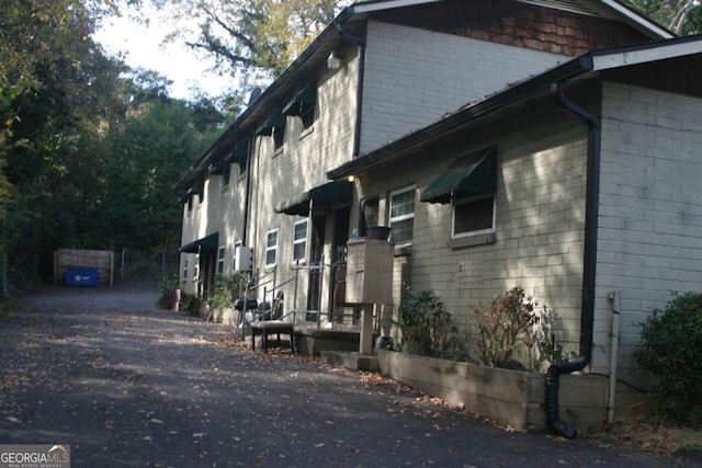 view of side of home featuring brick siding