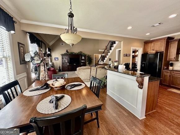 dining room with recessed lighting, stairway, dark wood-style floors, and crown molding