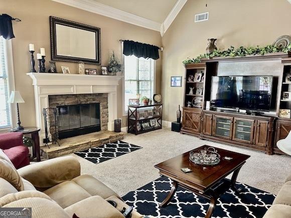 carpeted living room featuring visible vents, a fireplace, lofted ceiling, and ornamental molding