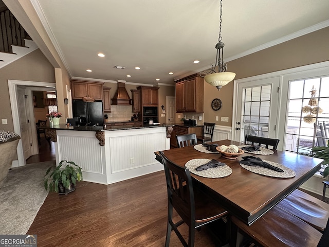 dining space with a wainscoted wall, visible vents, recessed lighting, dark wood-type flooring, and crown molding