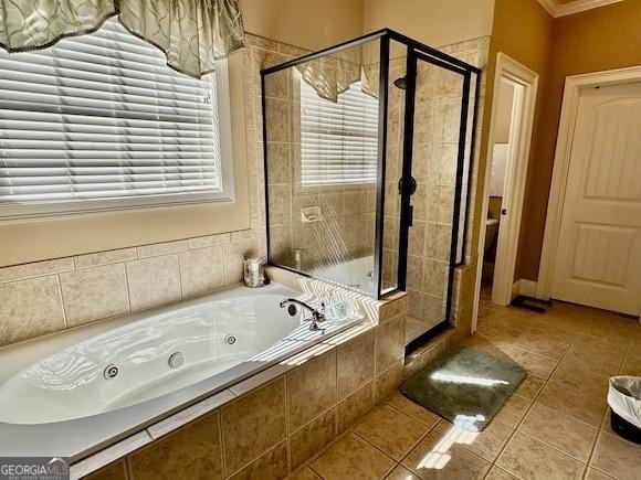 bathroom with crown molding, a stall shower, a whirlpool tub, and tile patterned flooring