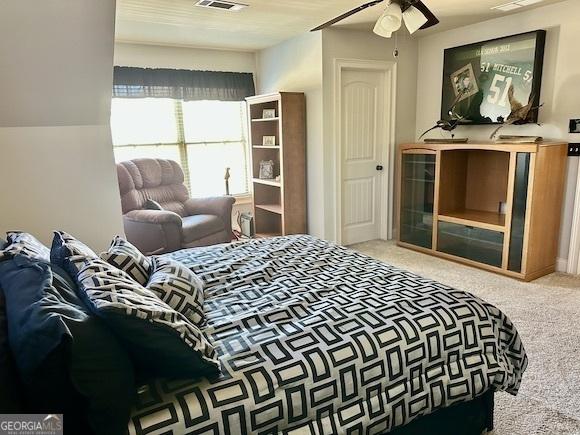 bedroom featuring carpet, visible vents, and ceiling fan