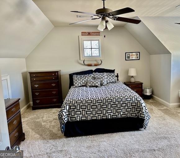 carpeted bedroom with baseboards, lofted ceiling, and a ceiling fan