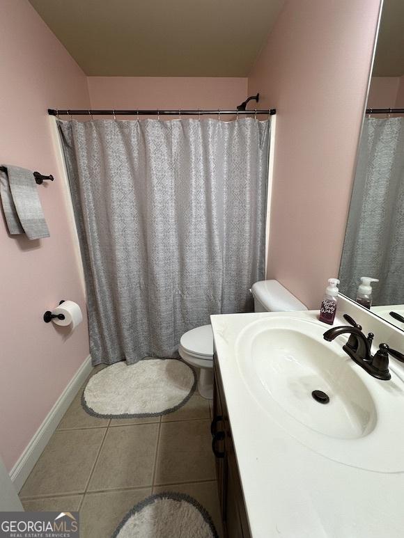 full bath featuring vanity, tile patterned floors, toilet, and baseboards