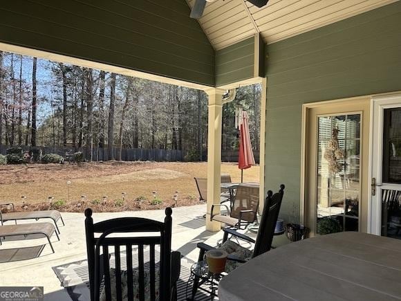 view of patio featuring outdoor dining area and fence