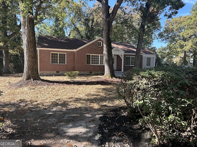 single story home with brick siding and crawl space