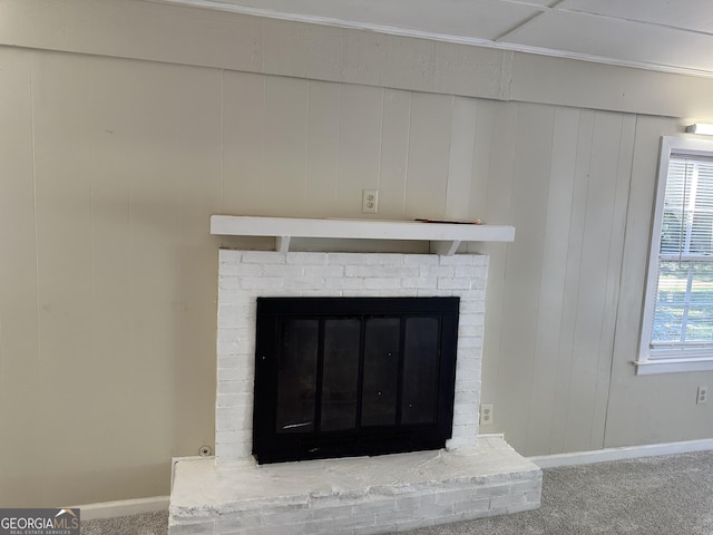 details with a fireplace, baseboards, and carpet