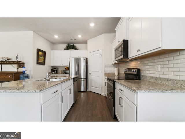 kitchen featuring dark wood-style flooring, white cabinets, stainless steel appliances, and a sink