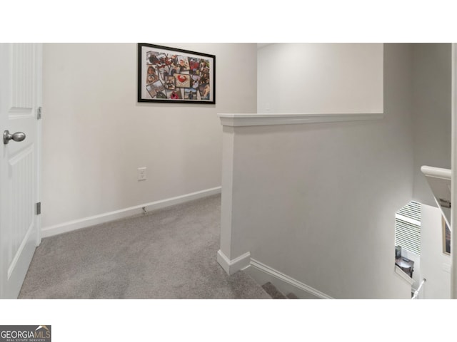 interior space featuring baseboards and carpet flooring