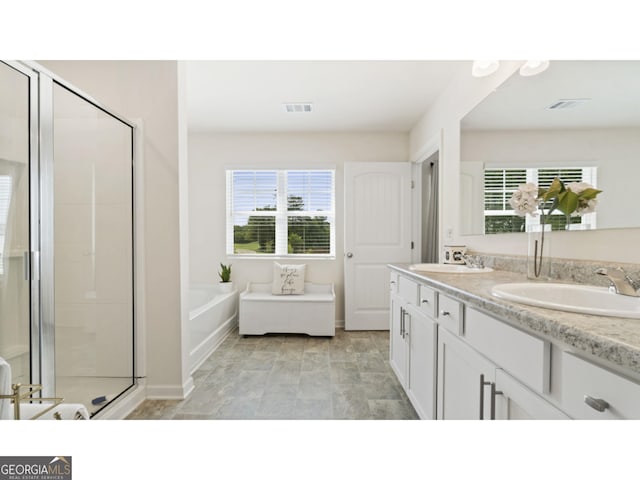 bathroom featuring a shower stall, visible vents, and a sink