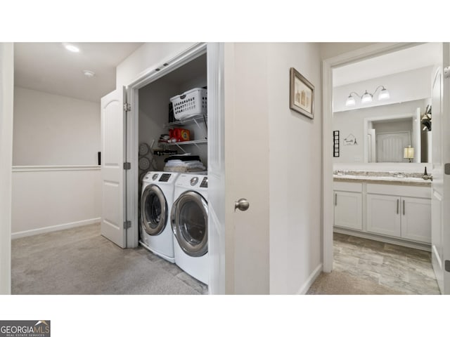 laundry area with light carpet, laundry area, independent washer and dryer, and baseboards