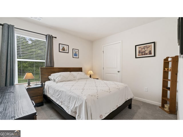 bedroom with visible vents, carpet, and baseboards