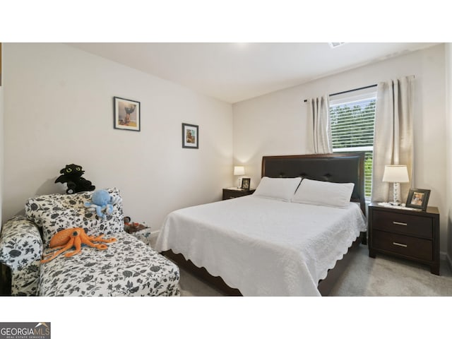 bedroom featuring light colored carpet