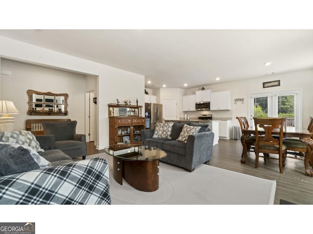 living room featuring recessed lighting and dark wood-type flooring