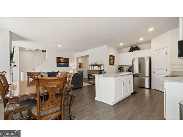 kitchen featuring decorative backsplash, appliances with stainless steel finishes, dark wood finished floors, and white cabinetry